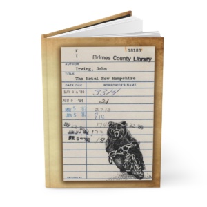 Heid Pitre writing journal with an old library borrowers card on the cover of Hotel New Hampshire for book lovers and librarians.