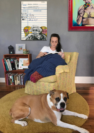 Heidi Pitre illustration of Eudora Welty in a floral chair in pen and ink and watercolor on an oversized canvas print.